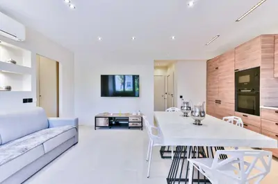 a living room with a table and a couch at Cosy apartment with parking - Cannes - Mobility Lease in Cannes