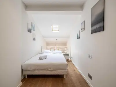 a white bedroom with a bed in a room at Bright duplex-Cannes Centre -Mobility lease in Cannes