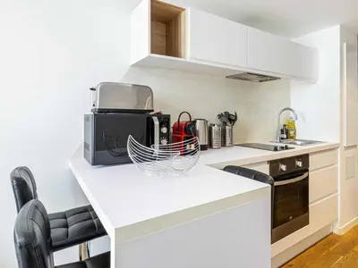 a kitchen with white cabinets and a counter top at Bright duplex-Cannes Centre -Mobility lease in Cannes