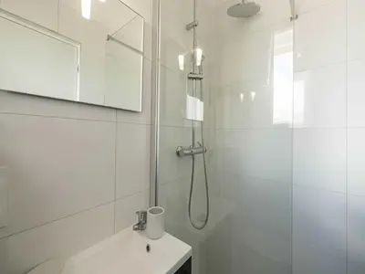 a white bathroom with a shower and a sink at Sublime studio - Cannes center - Mobility lease in Cannes