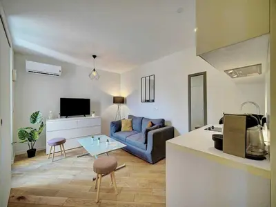 a living room with a couch and a table at Charming apartment, Suquet Cannes - Mobility lease in Cannes