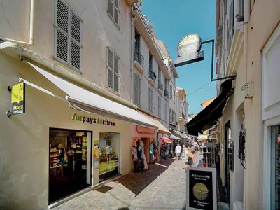a street with shops and buildings in a city at Charming apartment, Suquet Cannes - Mobility lease in Cannes