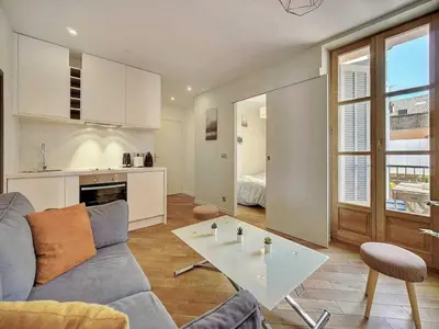 a living room with a couch and a table at Charming apartment, Suquet Cannes - Mobility lease in Cannes