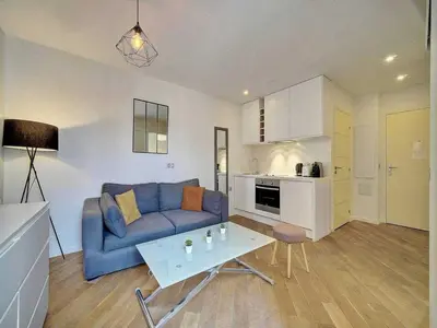 a living room with a blue couch and a table at Charming apartment, Suquet Cannes - Mobility lease in Cannes