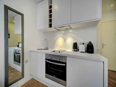 a white kitchen with a sink and a stove at Charming apartment, Suquet Cannes - Mobility lease in Cannes