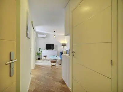 a hallway with a door leading to a living room at Charming apartment, Suquet Cannes - Mobility lease in Cannes