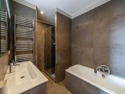 a bathroom with a bath tub and a sink at Appt Exclusif - 4BR 8P- Parking - Croisette in Cannes