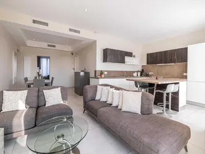 a living room with a couch and a table at Appt Exclusif - 4BR 8P- Parking - Croisette in Cannes