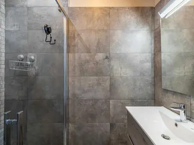 a shower with a glass door and a sink in a bathroom at Appt Exclusif - 4BR 8P- Parking - Croisette in Cannes