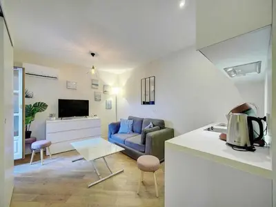 a living room with a couch and a table at Cosy flat in Cannes - Mobility lease in Cannes