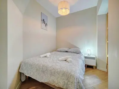 a bedroom with a bed with two pillows on it at Cosy flat in Cannes - Mobility lease in Cannes