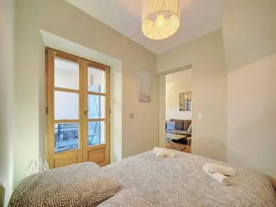 a bedroom with a large bed and a window at Cosy flat in Cannes - Mobility lease in Cannes