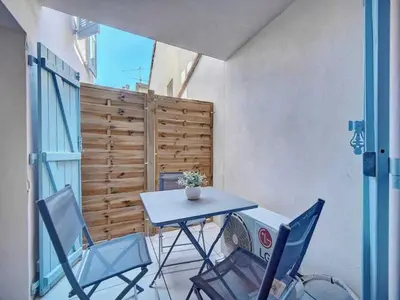 a small balcony with a table and two chairs at Cosy flat in Cannes - Mobility lease in Cannes