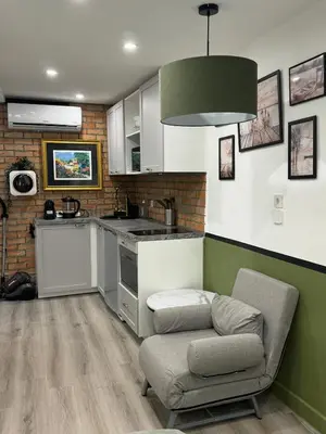 a kitchen with a couch and a kitchen with a sink at Studio - Suquet Forville in Cannes