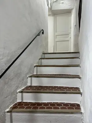 a stairway with a white door and a brick staircase at Studio - Suquet Forville in Cannes
