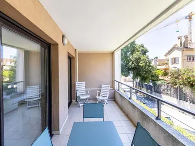 a balcony with chairs and a table on a balcony at Charming apt with balcony pool - 1BD 2P - Cannes in Cannes