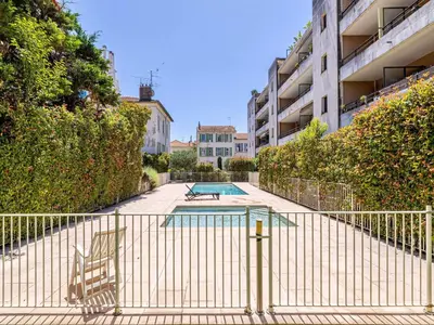 a swimming pool in the middle of a building at Charming apt with balcony pool - 1BD 2P - Cannes in Cannes