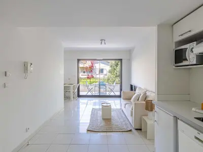 a kitchen and living room with a view of a patio at Charming apt with balcony pool - 1BD 2P - Cannes in Cannes