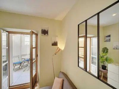 a living room with a couch and a mirror at Lovely renovated apart Terrace - Mobility lease in Cannes