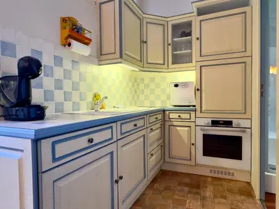 a kitchen with white cabinets and a sink at Bela Vista By SCLS Locations in Cannes