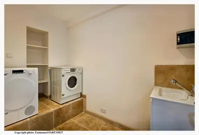 a laundry room with a washing machine and a sink at Bela Vista By SCLS Locations in Cannes