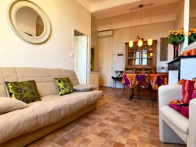 a living room with a couch and a dining room at Bela Vista By SCLS Locations in Cannes