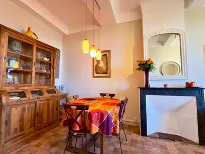 a dining room with a table and a mirror at Bela Vista By SCLS Locations in Cannes