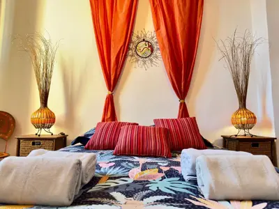 a bed with two pillows on it with two vases at Bela Vista By SCLS Locations in Cannes
