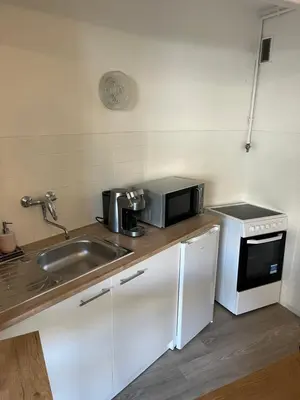 a kitchen with a sink and a microwave at Coquet studio 10 min de Cannes in Le Cannet