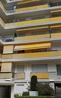 an apartment building with balconies and a sign on it at Coquet studio 10 min de Cannes in Le Cannet