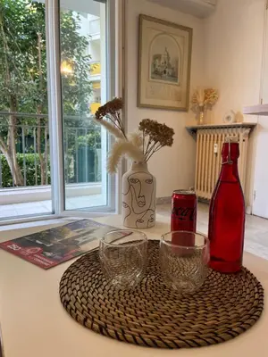 a table with two bottles and two glasses on it at Coquet studio 10 min de Cannes in Le Cannet
