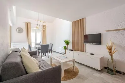 a living room with a couch and a tv at Studio Design et Cosy à 8 min à Pied des Plages in Cannes