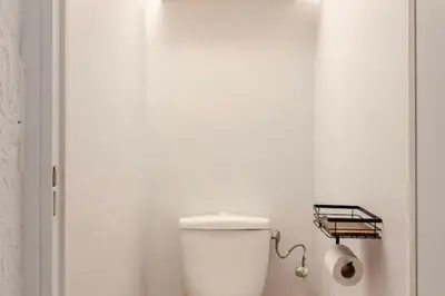a bathroom with a toilet in a white room at Studio Design et Cosy à 8 min à Pied des Plages in Cannes