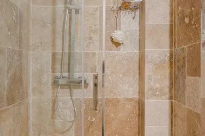 a shower with a hose in a bathroom at Studio Design et Cosy à 8 min à Pied des Plages in Cannes