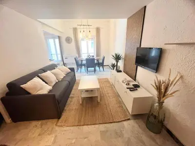a living room with a couch and a table at Studio Design et Cosy à 8 min à Pied des Plages in Cannes