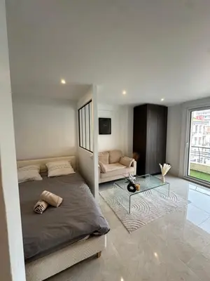 a bedroom with a bed and a glass table at Suite le Venitia - Appartement standing in Cannes