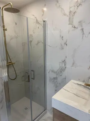 a bathroom with a shower with a glass door at Suite le Venitia - Appartement standing in Cannes