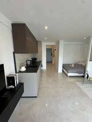 a kitchen with a bed in the middle of a room at Suite le Venitia - Appartement standing in Cannes