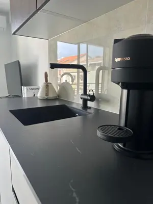 a kitchen counter with a sink and a coffee maker at Suite le Venitia - Appartement standing in Cannes