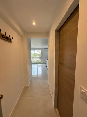 a hallway with a wooden door in a house at Suite le Venitia - Appartement standing in Cannes