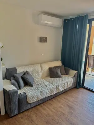a couch in a living room with pillows on it at Superbe appartement in Cannes