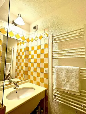a bathroom with a sink and a mirror at Superbe appartement in Cannes