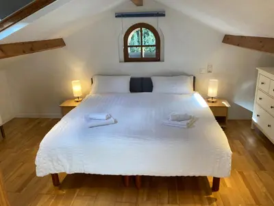 a bedroom with a large white bed with two lamps at Charming apartment in Cannes in Cannes