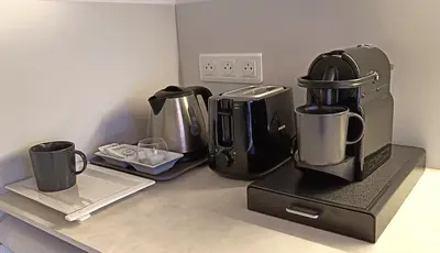 a kitchen counter with a coffee maker and two coffee cups at Charming apartment in Cannes in Cannes