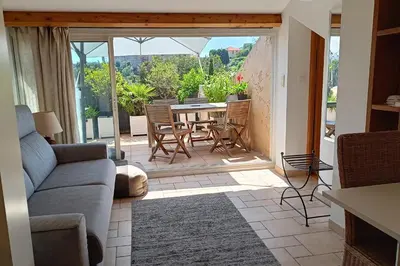 a living room with a couch and a table and chairs at Charming apartment in Cannes in Cannes