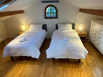 a bedroom with two beds with white sheets and a window at Charming apartment in Cannes in Cannes
