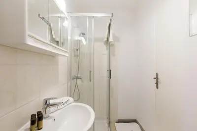 a bathroom with a sink and a shower at Le Lido YourHostHelper in Cannes