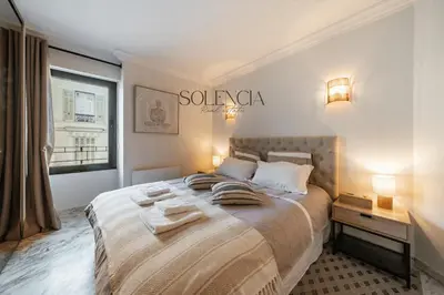 a bedroom with a large bed with towels on it at 2 pièces rue d'Antibes - Climatisation in Cannes