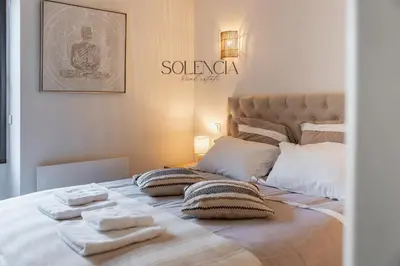 a bedroom with a bed with towels on it at 2 pièces rue d'Antibes - Climatisation in Cannes