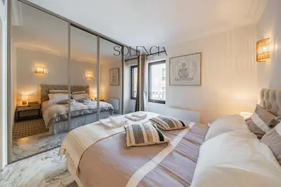 a bedroom with two beds and a large mirror at 2 pièces rue d'Antibes - Climatisation in Cannes